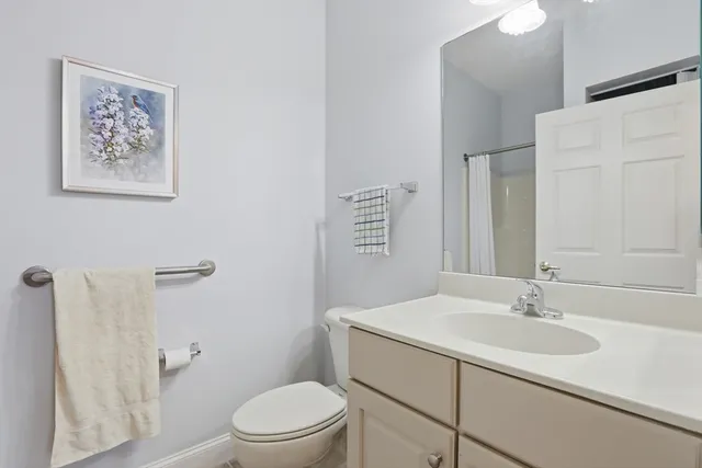 a bathroom with a sink toilet and a mirror