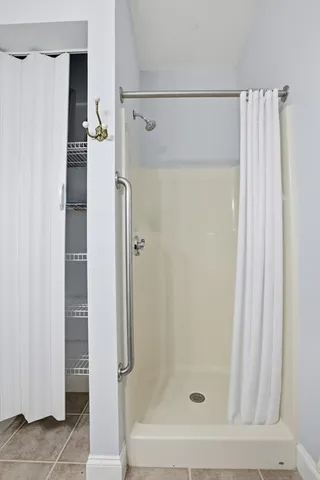 a bathroom with a shower and a bath tub