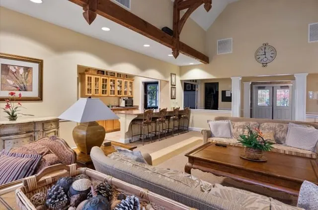 a room with furniture pool table and a large window