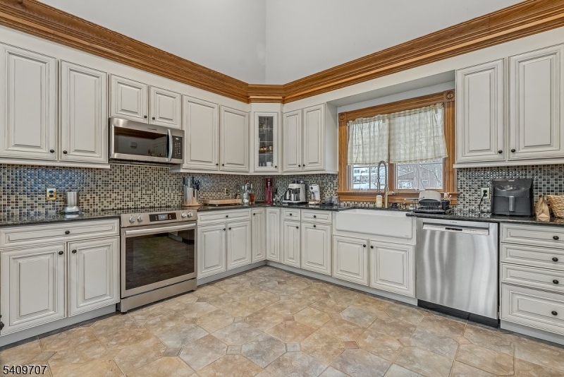 120 Goodale Road Newton, NJ 07860 - Photo 39 of 47 a kitchen with granite countertop white cabinets stainless steel appliances and a window