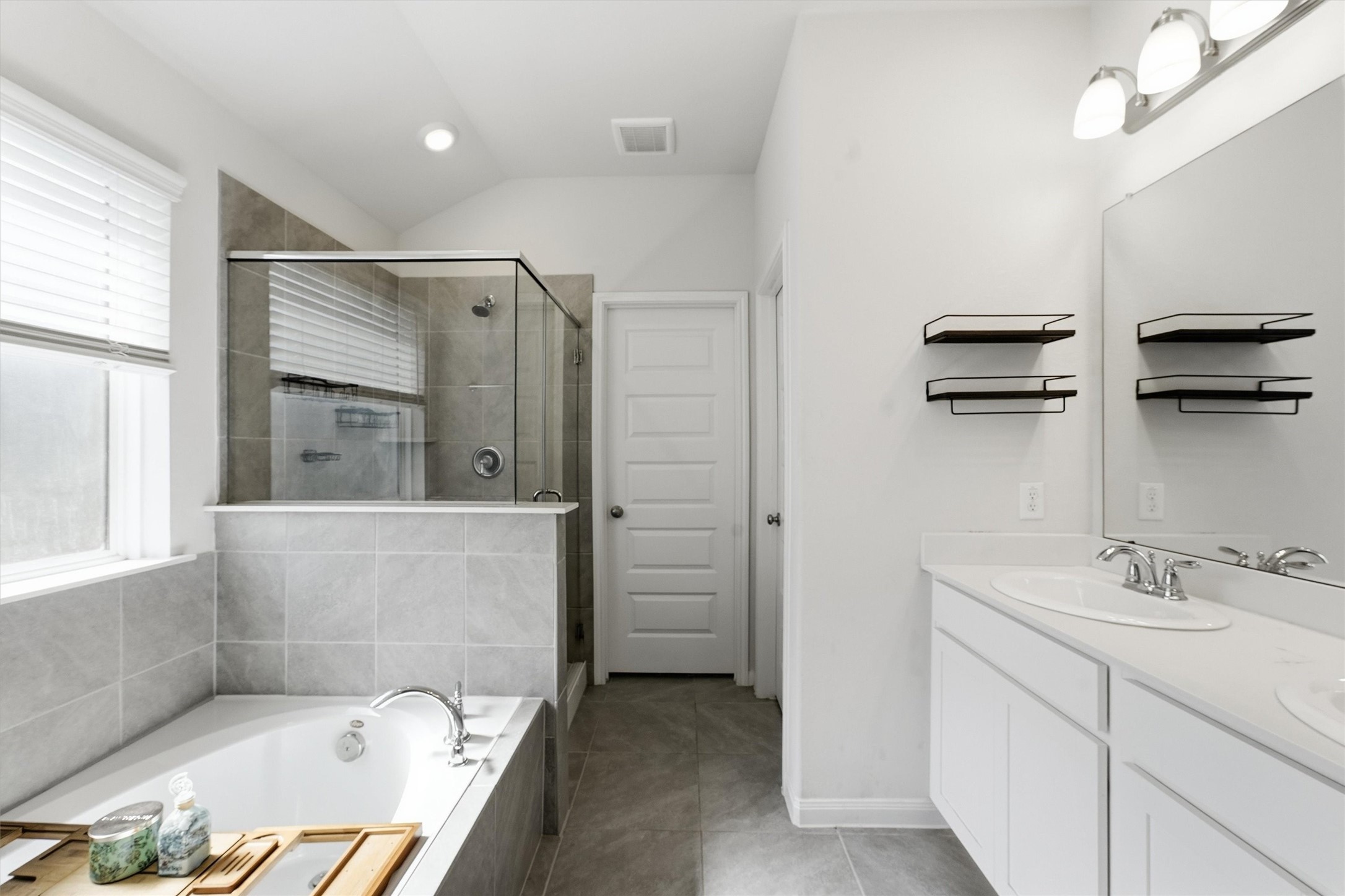 1007 Modesto Drive Rosharon, TX 77583 - Photo 14 of 25 Private primary bath featuring dual sinks, generous vanity space, and a glass-enclosed walk-in shower.