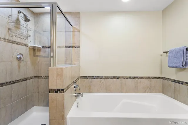 a bathroom with a bathtub and shower
