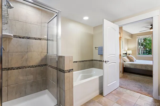 a bathroom with a bathtub and a shower