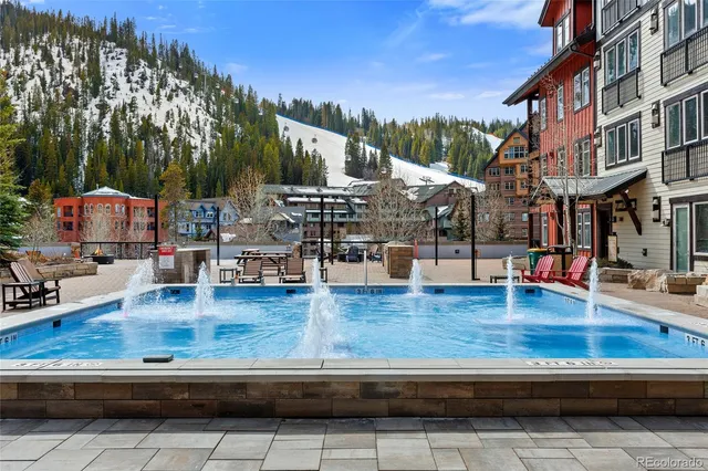 a view of swimming pool with outdoor seating