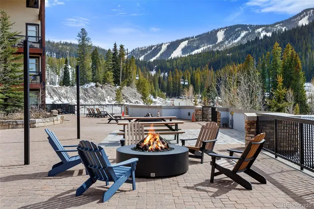 a view of a chairs and table in patio with a fire pit