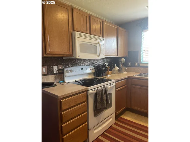 a kitchen with a refrigerator and a sink