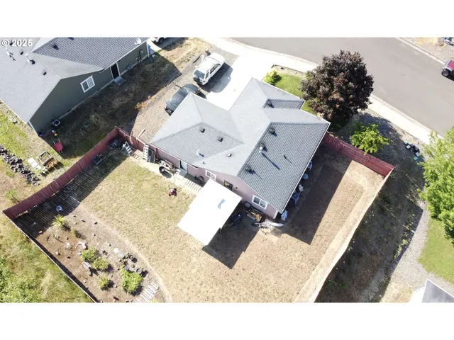 a backyard of a house with table and chairs