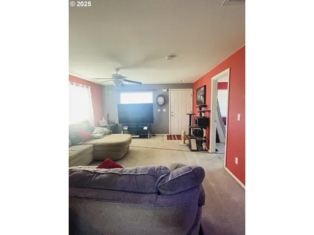 a bed sitting in a bedroom next to a bathroom