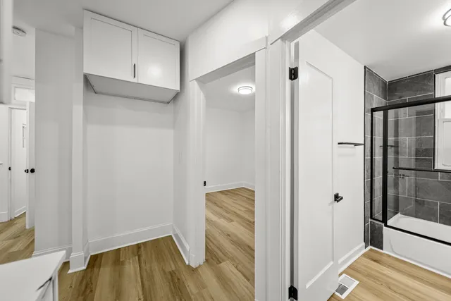 wooden floor in an empty room with a window