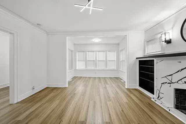 a kitchen with stainless steel appliances white cabinets and wooden floors