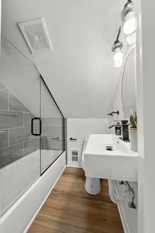 a picture of a bathroom with a door and a window