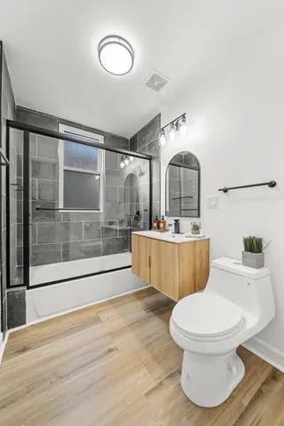 a view of a livingroom with a fireplace wooden floor and window