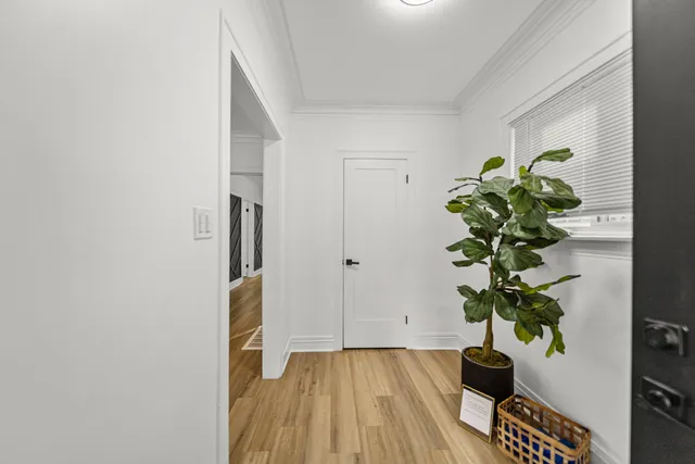 a view of an empty room with a fireplace and a window