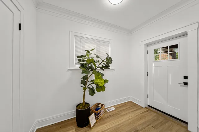 a view of a livingroom with wooden floor and a fireplace