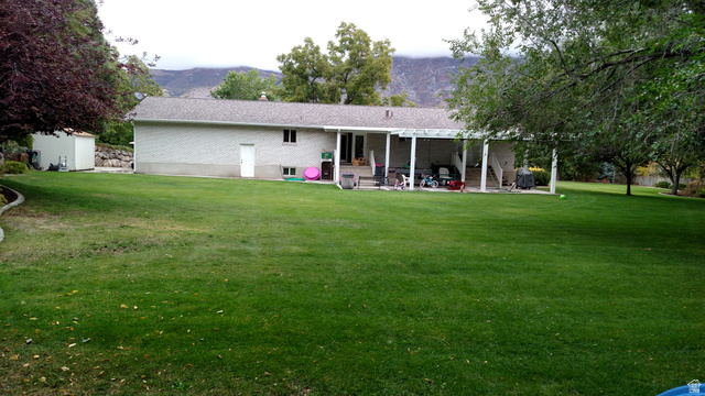 1360 Carterville Road Orem, UT 84097 - Photo 29 of 40 Back of house featuring a yard and a patio