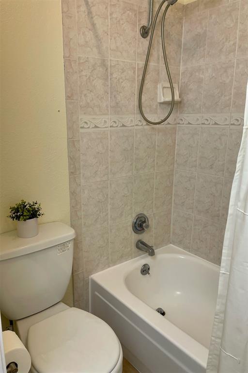 4748 Old Bent Tree Lane, Unit 1404 Dallas, TX 75287 - Photo 11 of 25 a white toilet sitting next to a bath tub and a shower