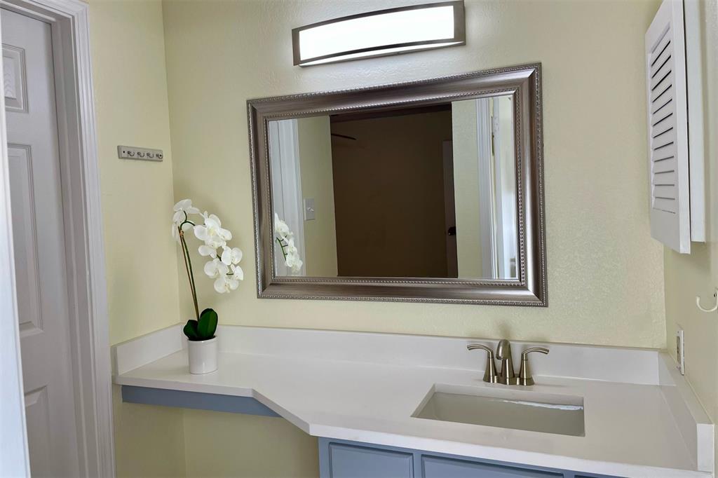 4748 Old Bent Tree Lane, Unit 1404 Dallas, TX 75287 - Photo 12 of 25 a bathroom with a sink and a mirror