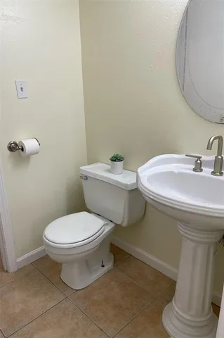 a white toilet sitting next to a bathroom sink