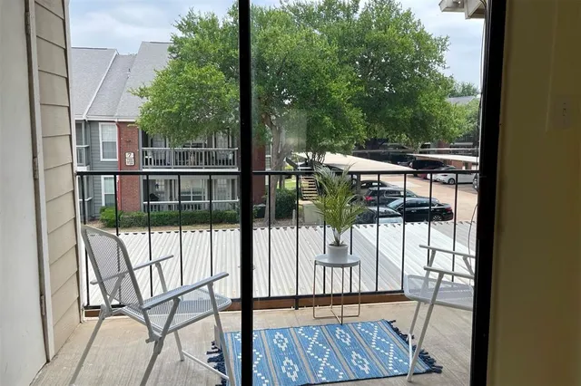 a view of balcony with wooden floor and fence