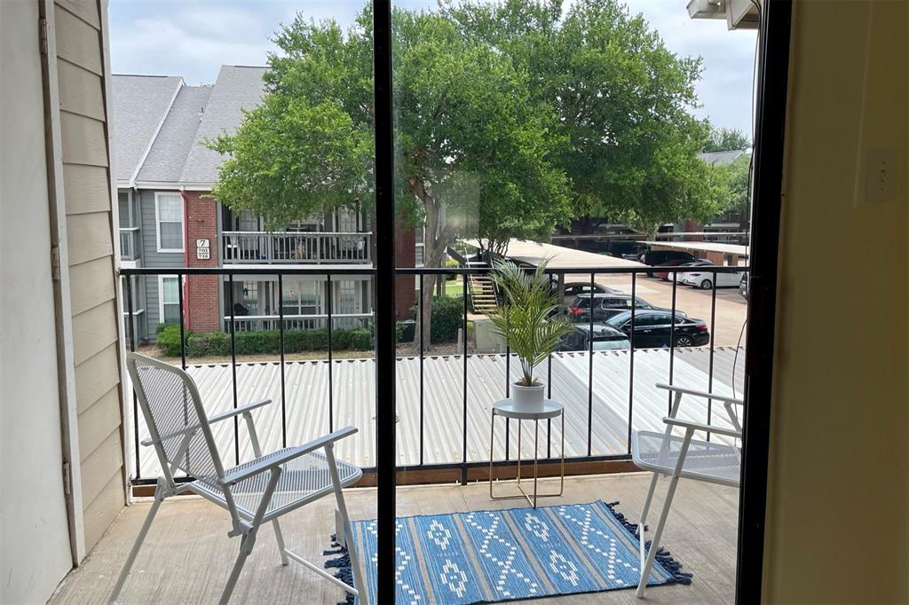 4748 Old Bent Tree Lane, Unit 1404 Dallas, TX 75287 - Photo 19 of 25 a view of balcony with wooden floor and fence