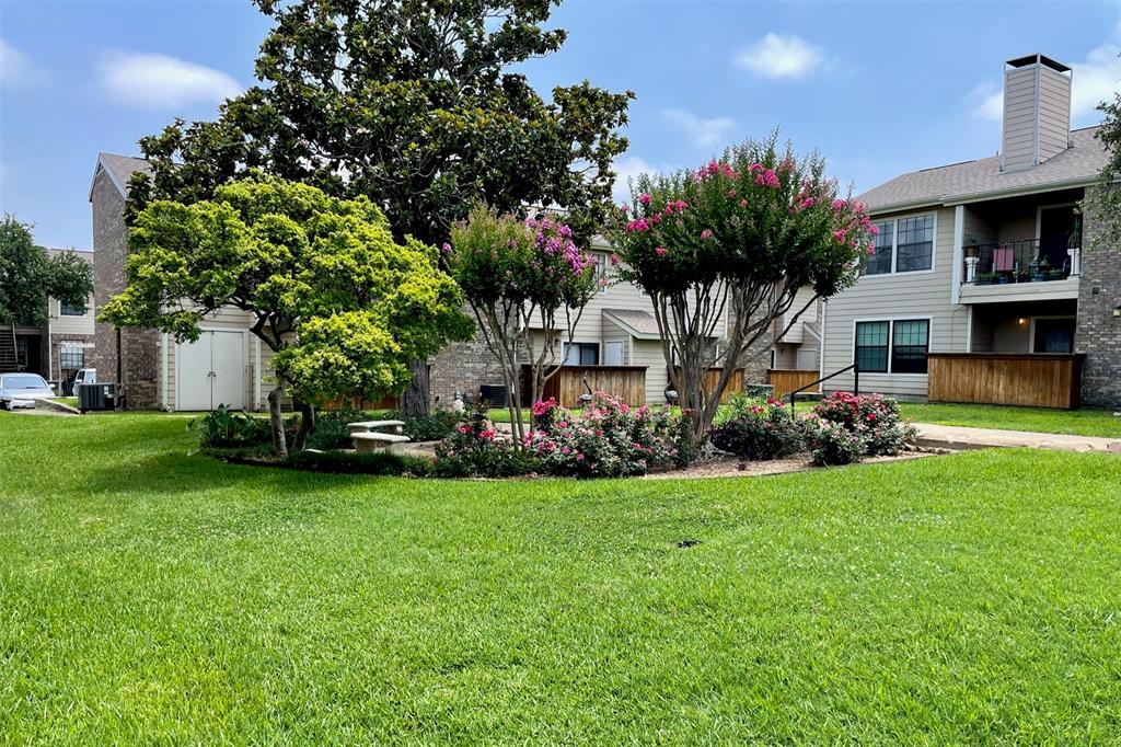 4748 Old Bent Tree Lane, Unit 1404 Dallas, TX 75287 - Photo 20 of 25 a front view of a house with garden and trees