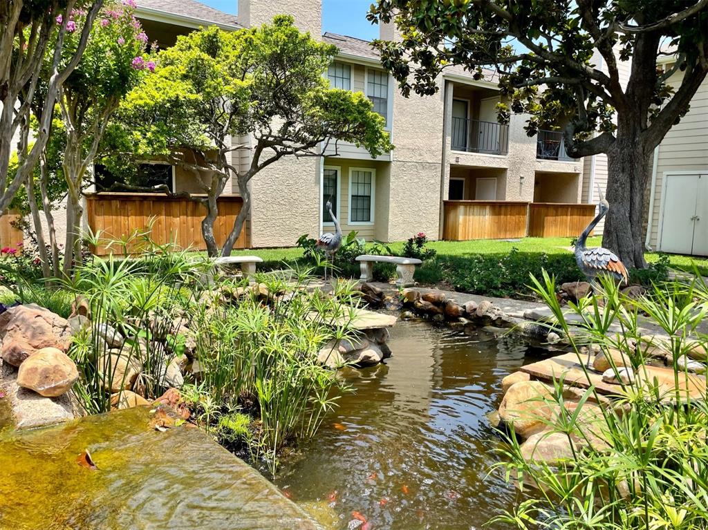 4748 Old Bent Tree Lane, Unit 1404 Dallas, TX 75287 - Photo 24 of 25 a backyard of a house with lawn chairs plants and large tree