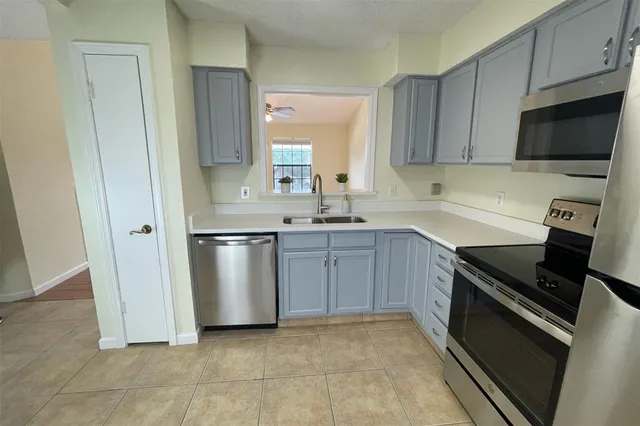 a kitchen with a sink stove and microwave
