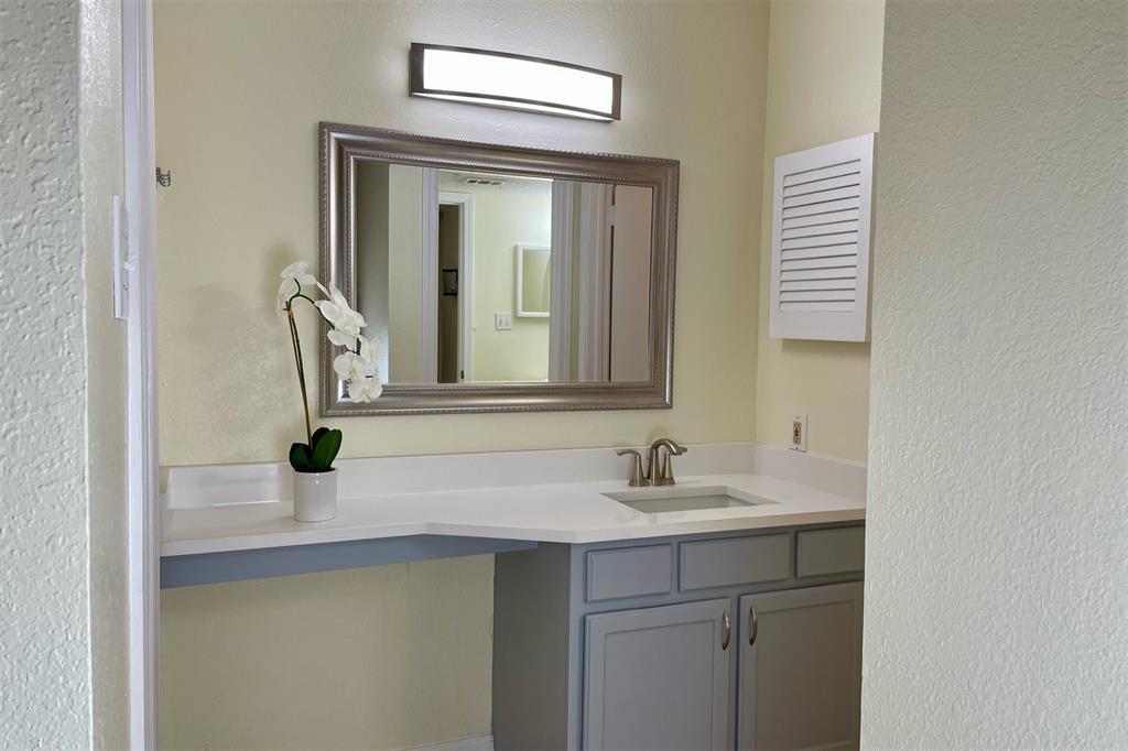 4748 Old Bent Tree Lane, Unit 1404 Dallas, TX 75287 - Photo 10 of 25 a bathroom with a sink and a mirror