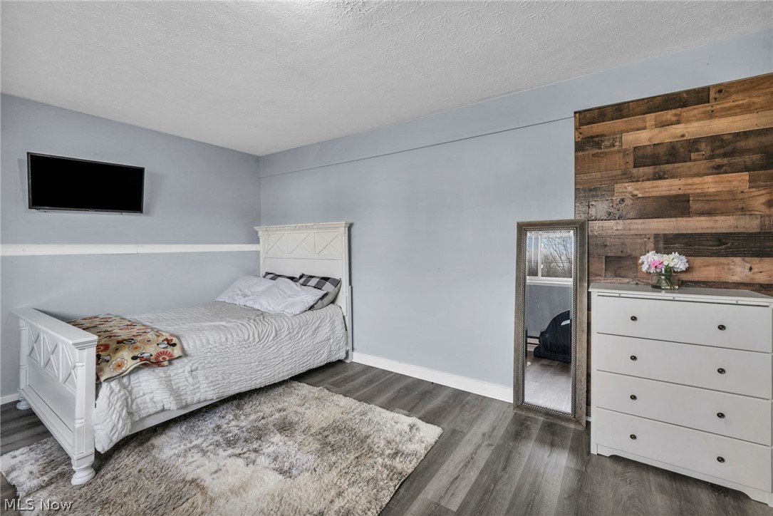 54 Park Road Painesville, OH 44077 - Photo 21 of 38 Bedroom featuring a textured ceiling and dark wood-style floors