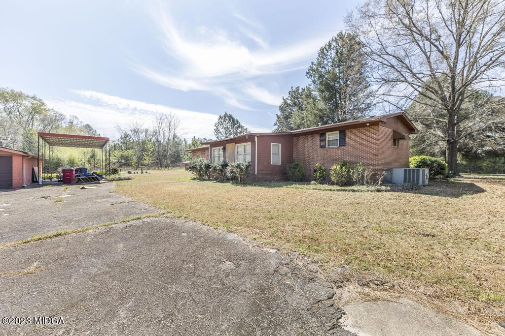 7369 Thomaston Road Macon, GA 31220 - Photo 21 of 25 a street view with residential house and wooden fence