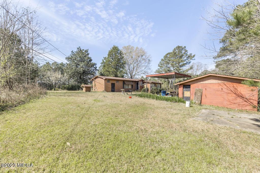 7369 Thomaston Road Macon, GA 31220 - Photo 24 of 25 a front view of a house with a yard and trees