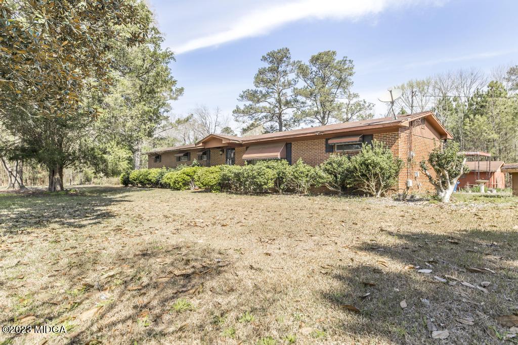 7369 Thomaston Road Macon, GA 31220 - Photo 4 of 25 a view of a yard with plants and trees