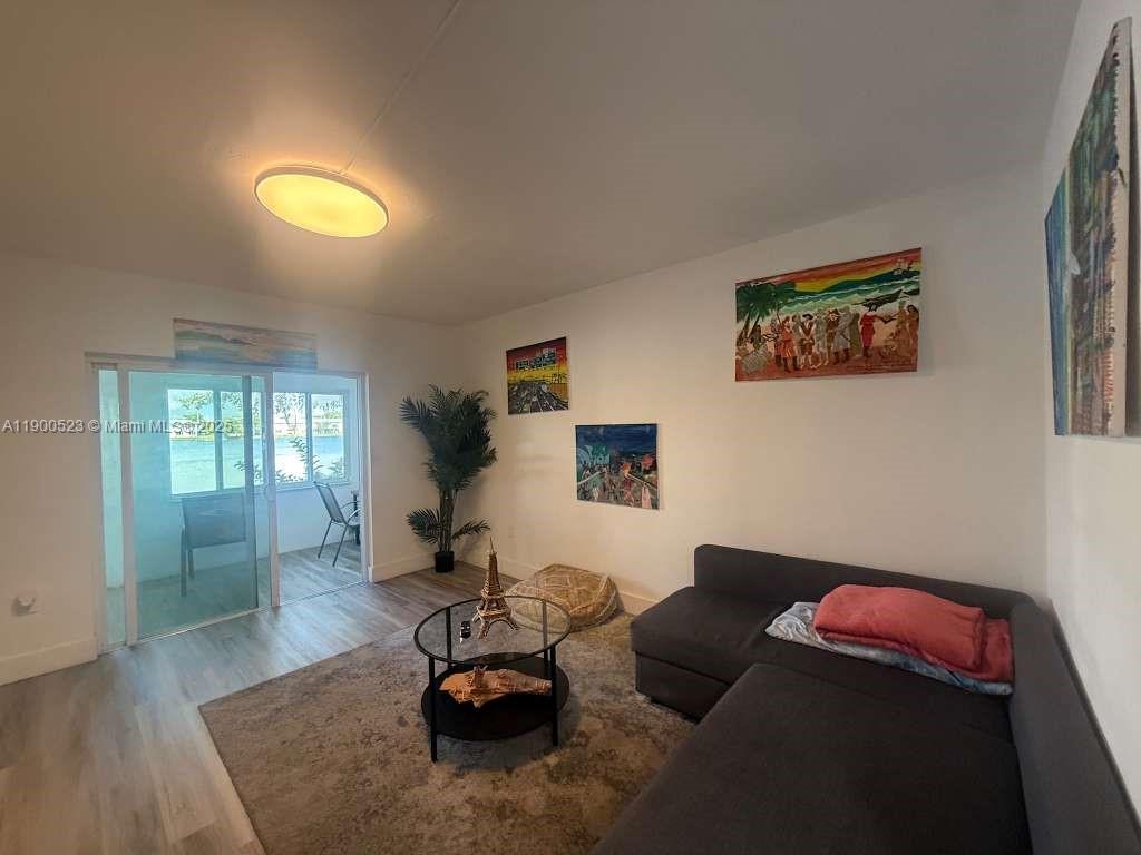 18900 Northeast 3rd Court, Unit 509 Miami, FL 33179 - Photo 1 of 19 a living room with furniture and a window