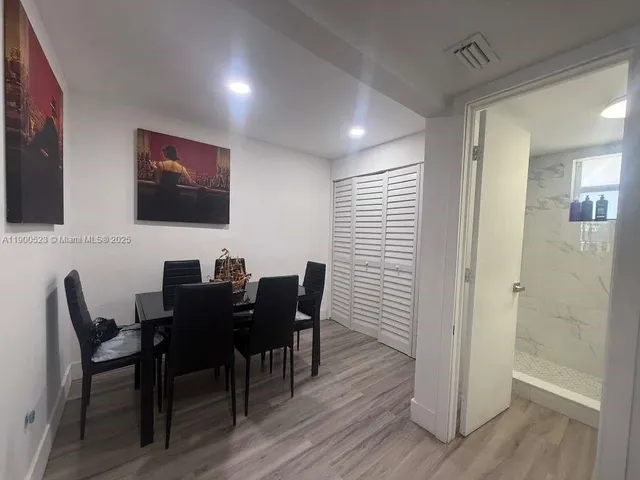 a view of a dining room with furniture and wooden floor