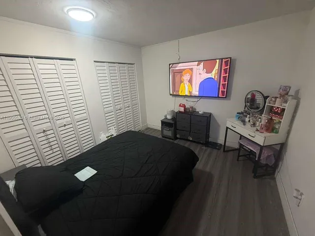 a bedroom with furniture and a window