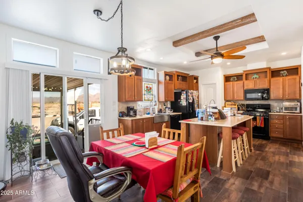 a kitchen that has a lot of cabinets a sink and appliances in it