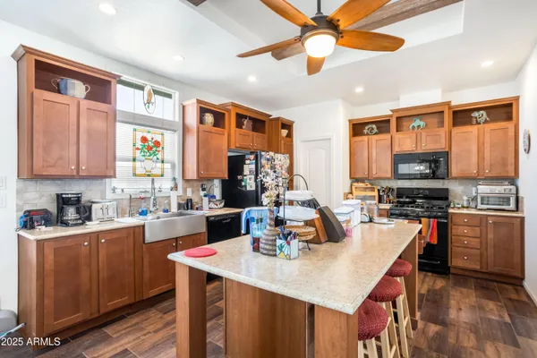 a kitchen with stainless steel appliances granite countertop a stove refrigerator and cabinets