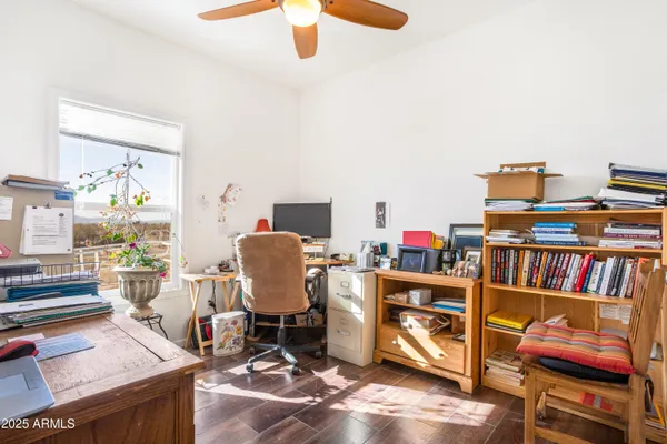 a living room with furniture a floor to ceiling window and kitchen view