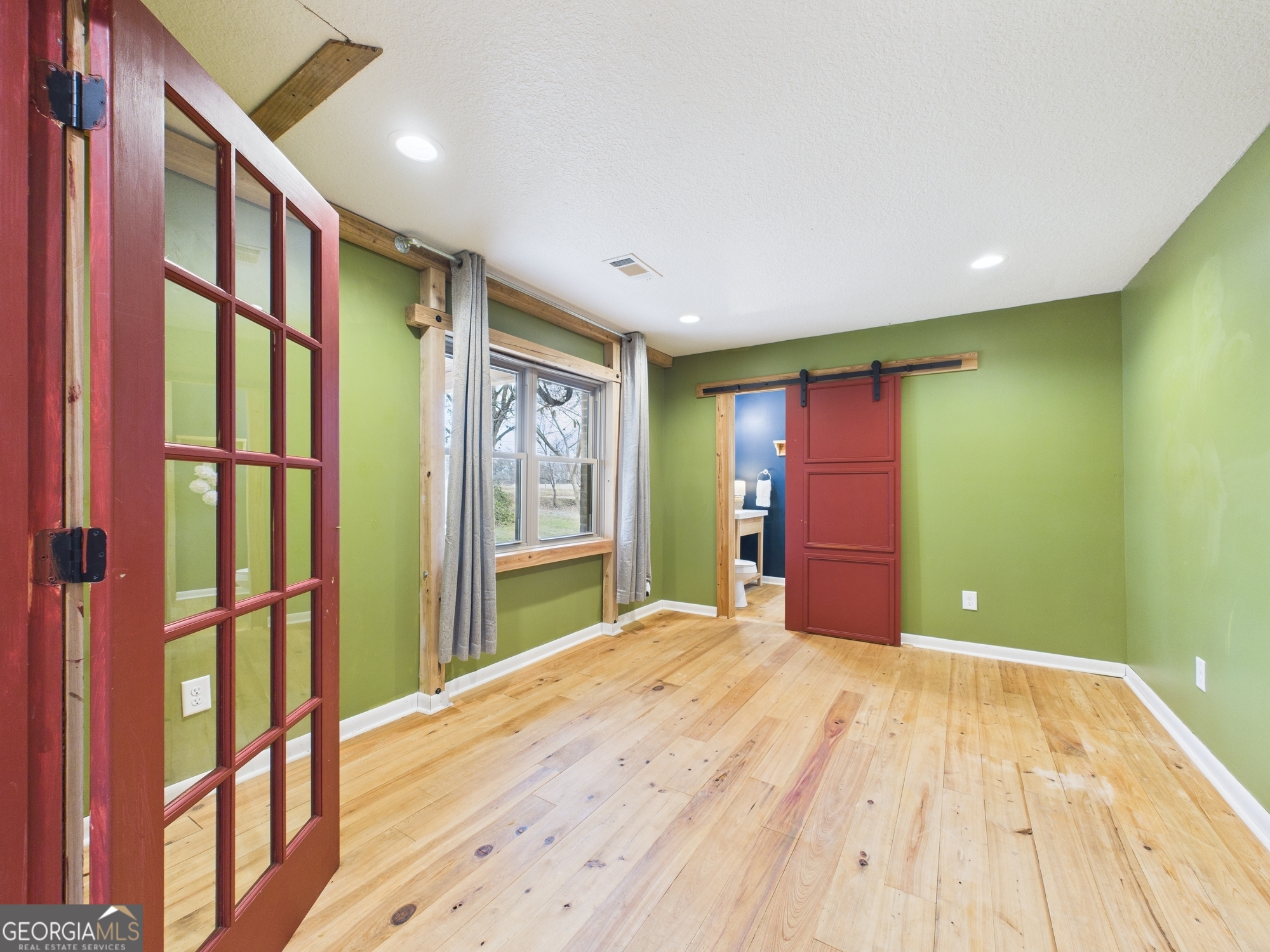 312 Henson Road Hawkinsville, GA 31036 - Photo 21 of 64 a bedroom with a bed and a large window