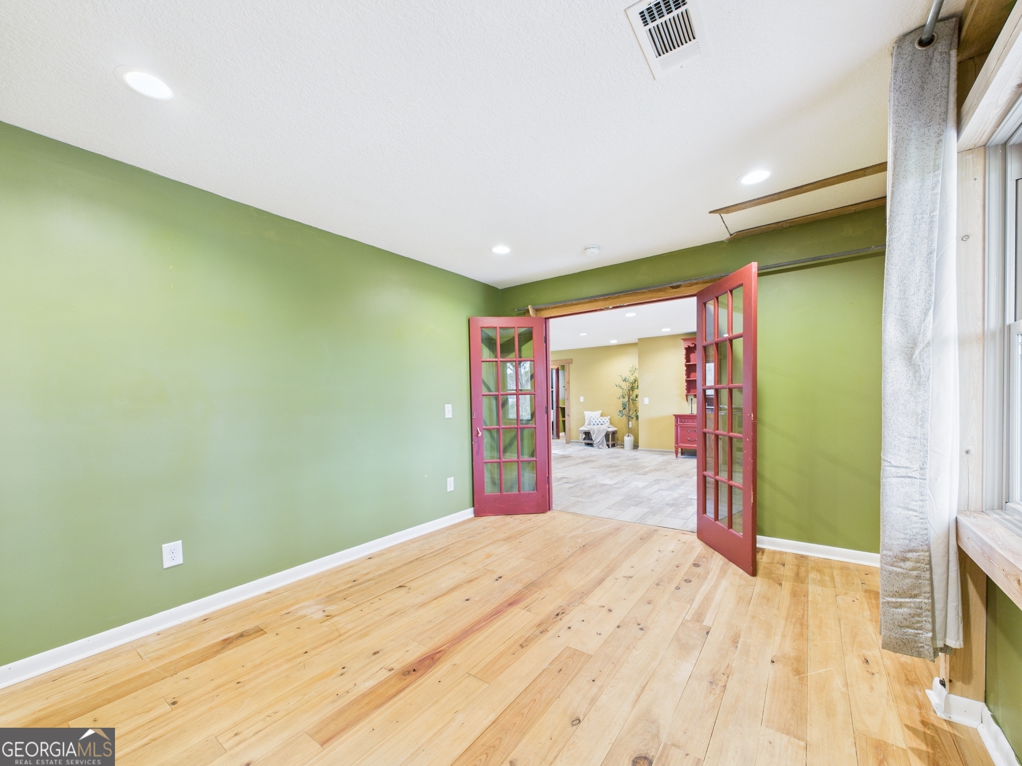 312 Henson Road Hawkinsville, GA 31036 - Photo 22 of 64 a bedroom with a bed and a large window