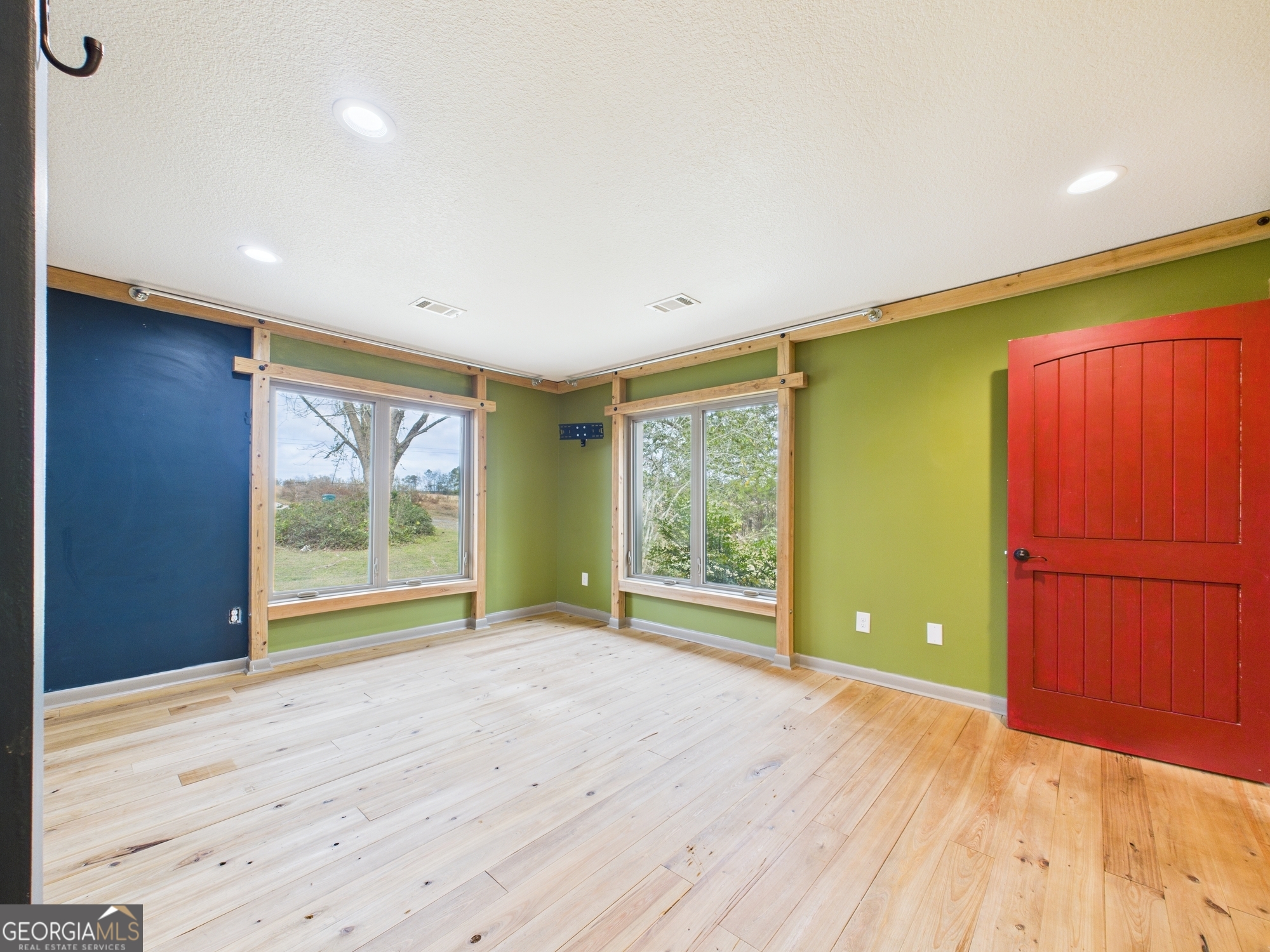 312 Henson Road Hawkinsville, GA 31036 - Photo 30 of 64 a view of an empty room with wooden floor and a window