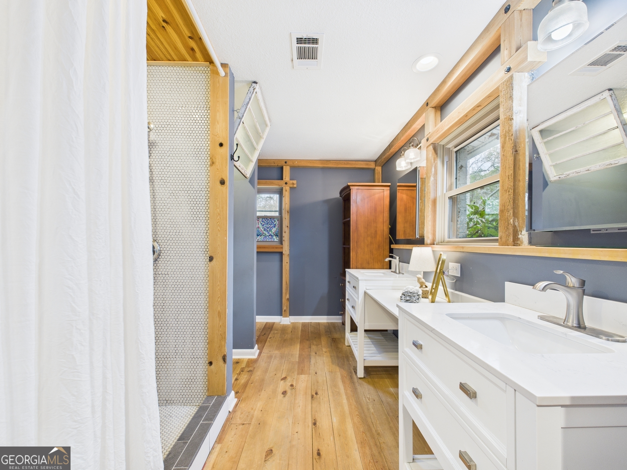 312 Henson Road Hawkinsville, GA 31036 - Photo 37 of 64 a bathroom with a sink a mirror and a shower