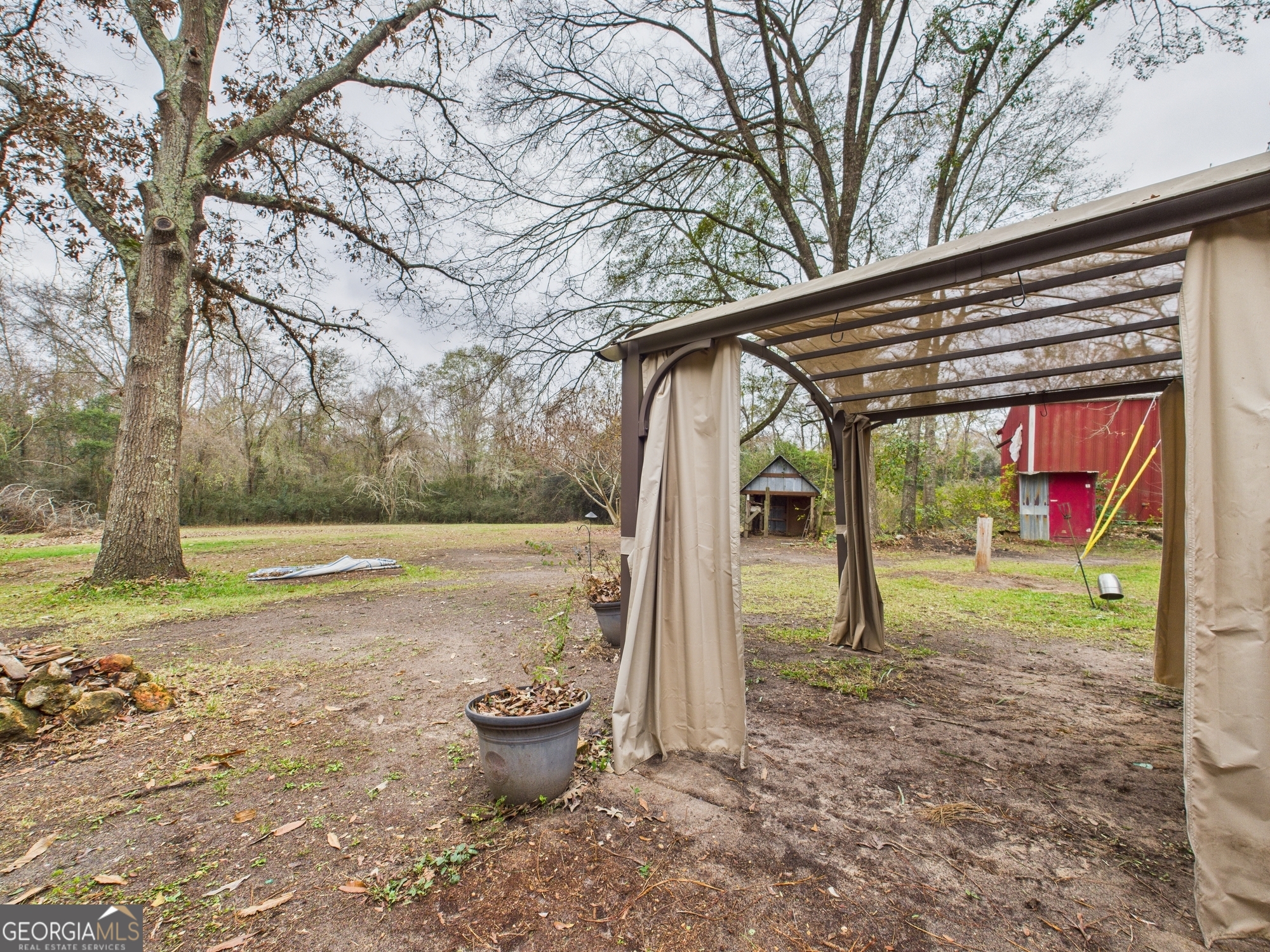 312 Henson Road Hawkinsville, GA 31036 - Photo 49 of 64 a backyard of a house with barbeque oven table and chairs