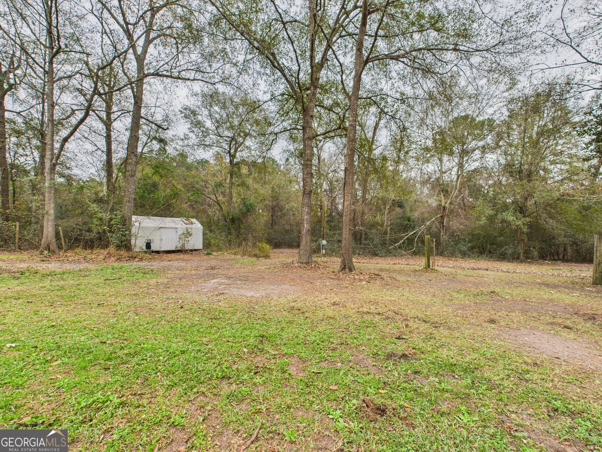 312 Henson Road Hawkinsville, GA 31036 - Photo 50 of 64 a backyard of a house with trees and entertaining space
