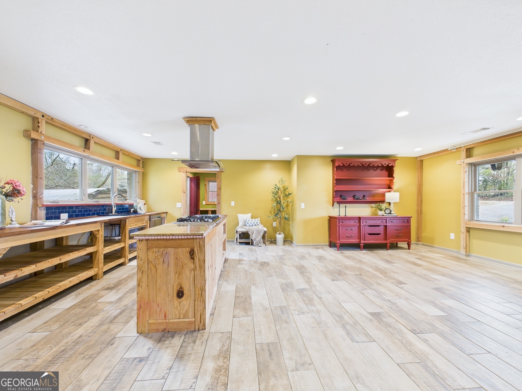 312 Henson Road Hawkinsville, GA 31036 - Photo 9 of 64 a view of a kitchen with kitchen island stainless steel appliances wooden floor and large windows
