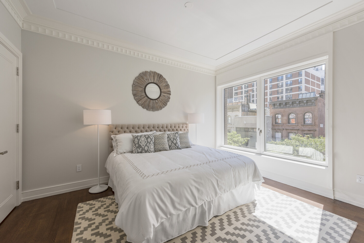 33 East 74th Street, Unit 5A Manhattan, NY 10021 - Photo 9 of 22 a bedroom with a large bed and a window