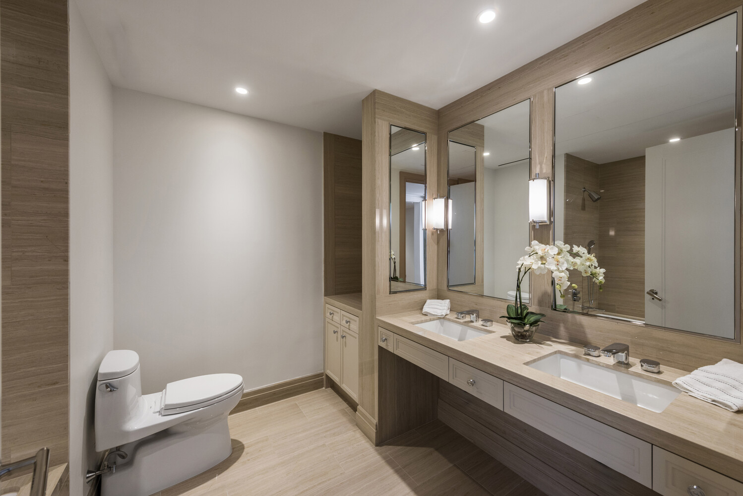 33 East 74th Street, Unit 5A Manhattan, NY 10021 - Photo 10 of 22 a bathroom with a double vanity sink toilet and a mirror