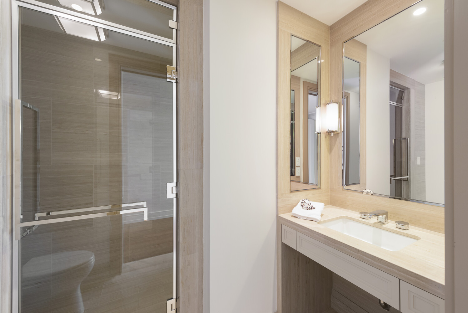 33 East 74th Street, Unit 5A Manhattan, NY 10021 - Photo 14 of 22 a bathroom with a granite countertop sink mirror and shower