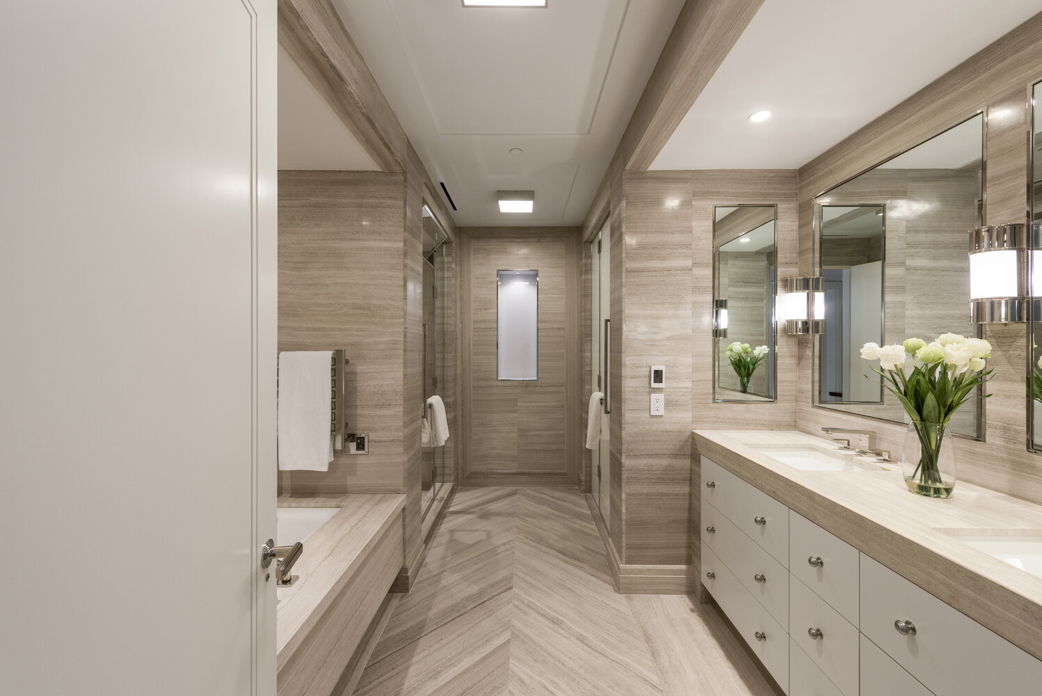 33 East 74th Street, Unit 5A Manhattan, NY 10021 - Photo 7 of 22 a spacious bathroom with a double vanity sink and a mirror