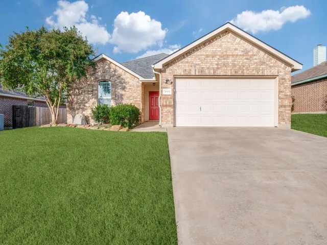 a view of a house with a yard and garage